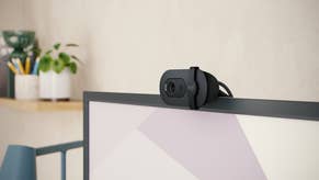 The Logitech Brio 100 webcam on top of a monitor.