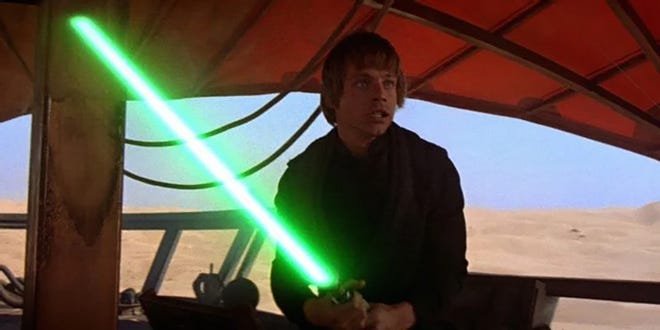 Mark Hamill as Luke Skywalker wielding a green lightsaber