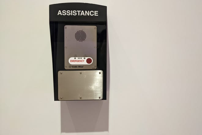 Photograph of Cameron Rowland's Lynch Law in America, an emergency call box on a white wall