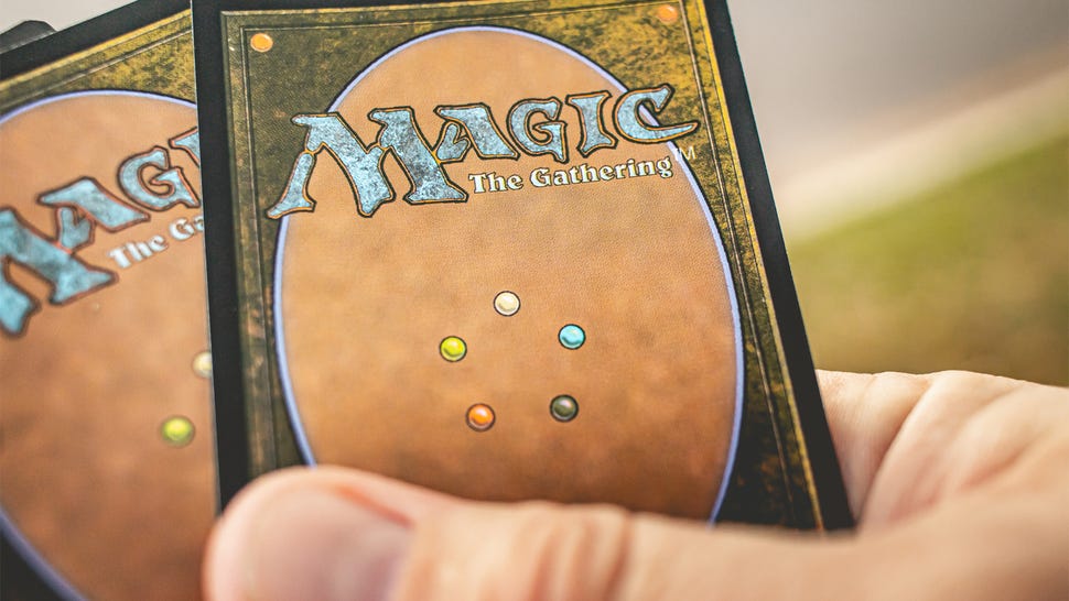 Photo showing a hand holding MTG cards