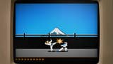 A close-up of an old computer monitor showing a sequence from 1984 classic martial arts game Karateka, with two fighters battling in front of a distant snow-capped mountain.