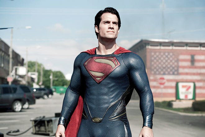 Still movie image of Superman standing outside in a parking lot