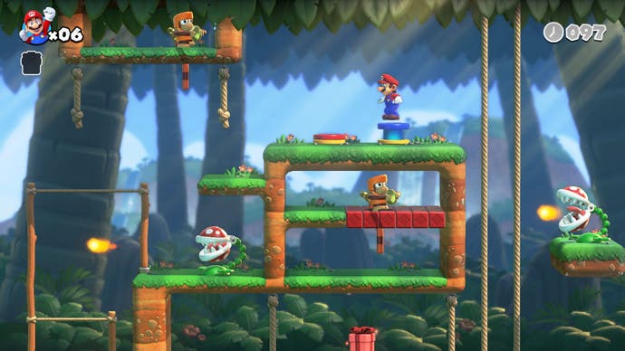 Mario vs Donkey Kong image showing Mario on a grassy platform in a jungle level