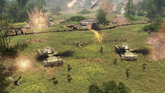 Soldiers and tanks advance toward trenches in a grassy field in Men Of War 2