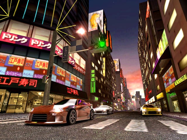 Cars lined up to race on city streets in a Midnight Club 2 screenshot.
