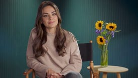 Mila Kunis sits next to a vase of sunflowers in the announcement video for World of Warcraft's Pet Pack for Ukraine charity bundle