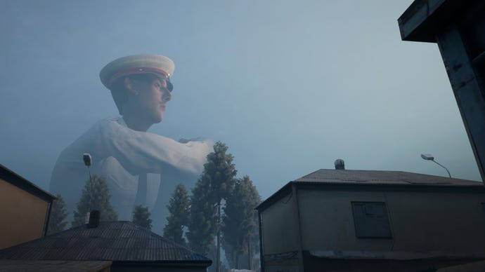 A giant policeman sits behind a town in a Militsioner screenshot.
