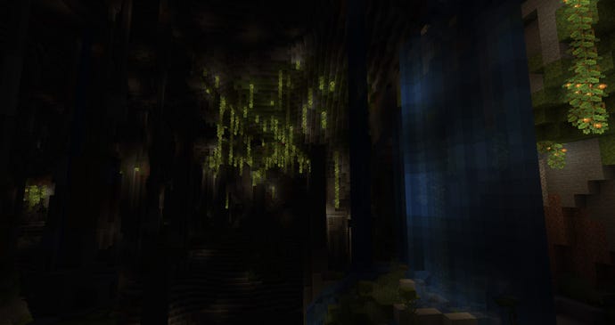 Minecraft experimental 1.18 snapshot - A dark cave lit by glowing vines in the lush cave biome and a waterfall.