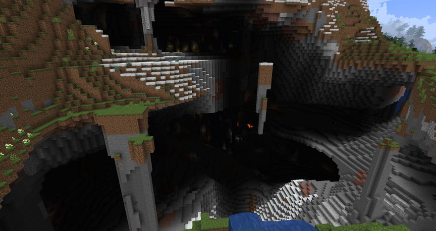 Minecraft experimental 1.18 snapshot - An extremely large cave mouth with two distinct levels. Deep inside the cave is lava glowing and interior waterfalls.
