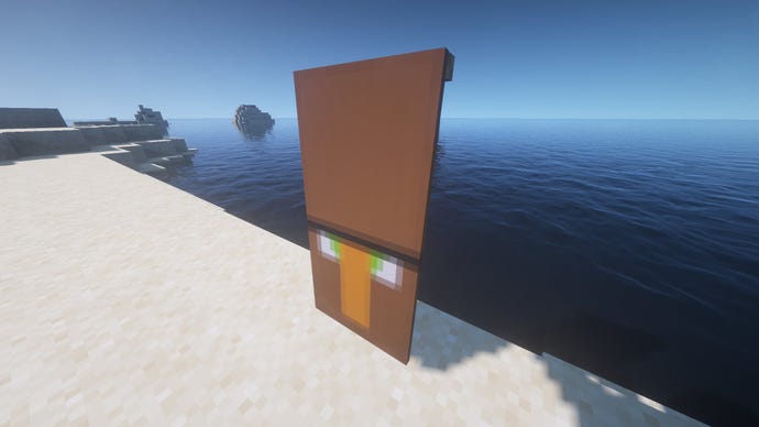 Một lá cờ nông dân trong Minecraft, được đặt trên mặt đất cạnh bờ biển.