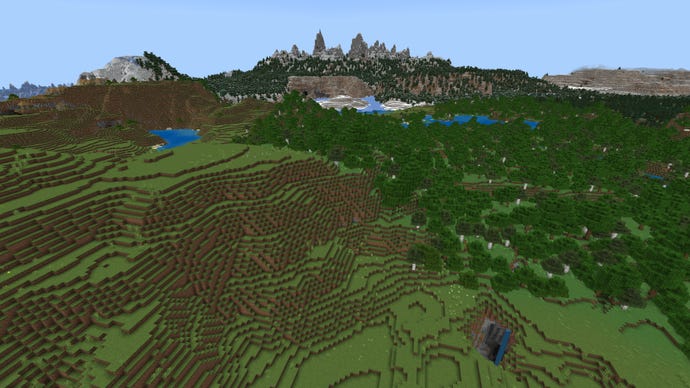 A rolling Minecraft landscape with plains on the left, forest on the right, and tall snowy mountains in the background.