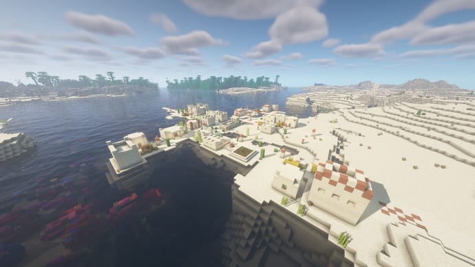 Bioma gurun Minecraft dengan sebuah desa di latar depan, dan hutan di kejauhan melintasi air