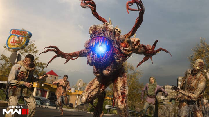 A 10-ft tall humanoid monster with extra tentacle arms and a wreath of heads/skulls around a glowing blue maw stands in a crowd of more "normal"-looking zombies. The Call of Duty Modern Warfare 3 logo appears in the corner of the screen.