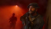 Captain Price walks through a corridor holding a gun with someone else behind him in MW3