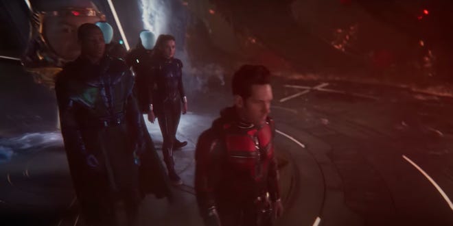Still image of the Ant-Man, Wasp, Kang, walking with Modok in the background