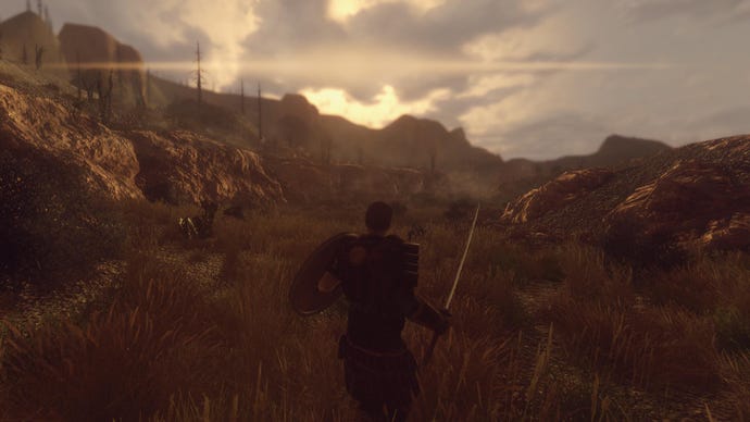 A man holds a sword and shield in a grassy plain the New California mod for Fallout: New Vegas