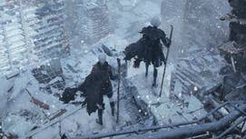 Nier Automata's 9S and 2B stood holding pipes on top of a dilapidated building, looking down at a city, snow covering all the buildings around them.