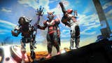 A No Man's Sky screenshot showing three players in elaborate spacesuits gathered on a planet's surface.