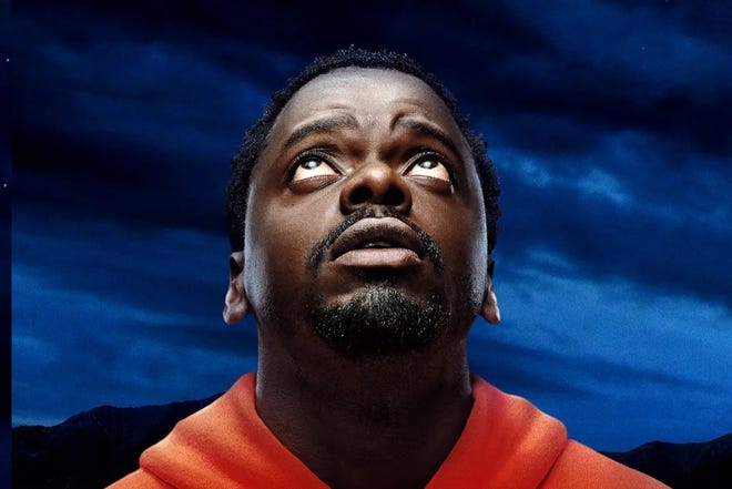 Daniel Kaluuya wearing an orange hoodie on the poster for Nope