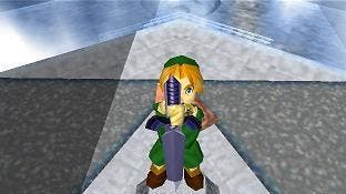 Link holds the Master Sword by the hilt in the Temple of Time in this shot from Ocarina of Time.