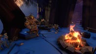 An Outer Wilds alien (?) plays the banjo by a fire.