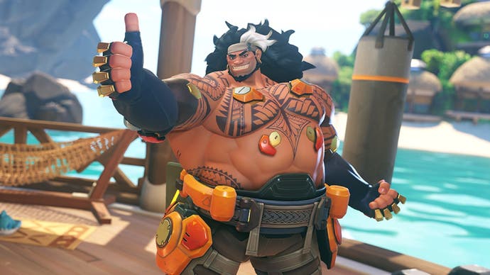 Promotional artwork showing new Overwatch 2 hero Mauga grinning at the camera and giving a thumbs-up in a tropical island setting.