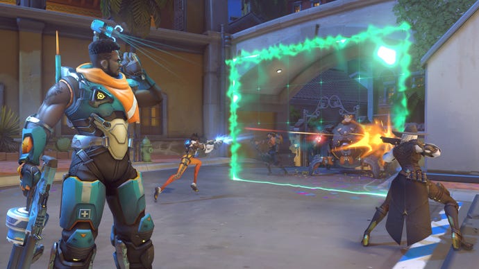 Baptiste, a hero in Overwatch 2, is shown standing on the left while his team fights on the right from behind one of Baptiste's barriers.