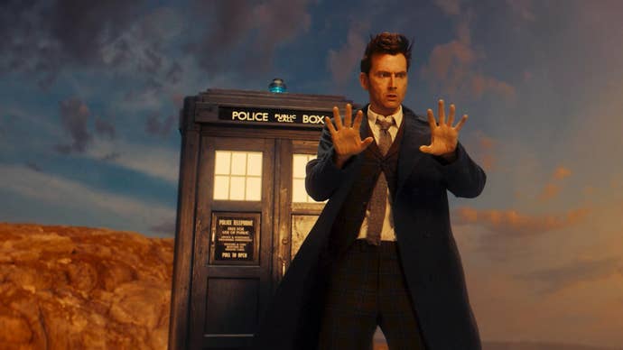 David Tennant as Dr Who stands outside the Tardis, examining his hands after a regeneration.