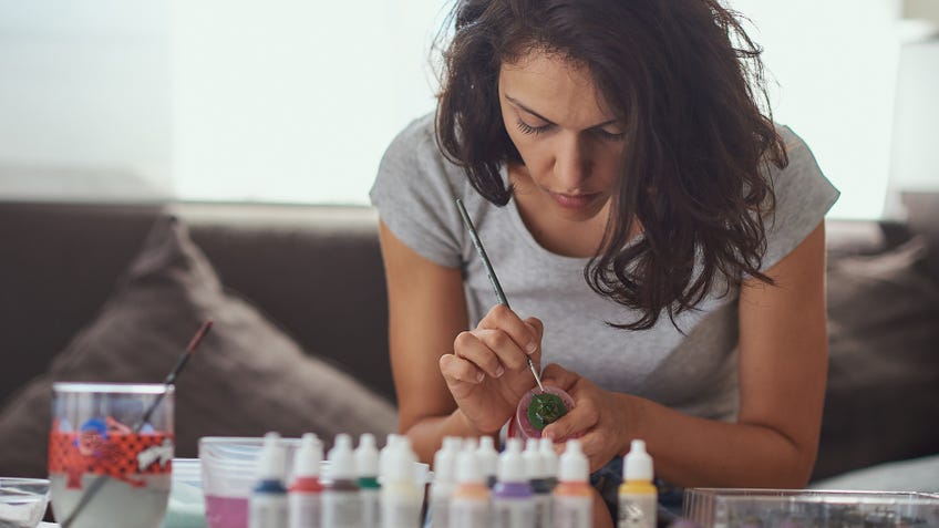A woman painting miniatures