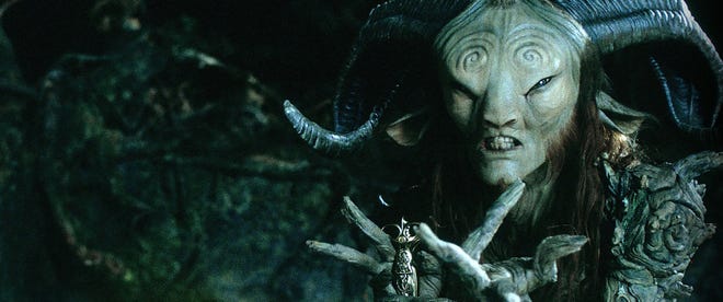 Still from Pan's Labyrinth. Doug Jones as the Faun with his hands outstretched