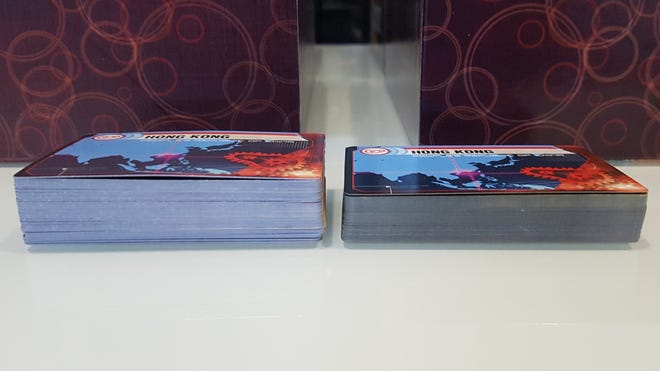 A counterfeit and real copy of board game Pandemic Legacy: Season 1 side-by-side