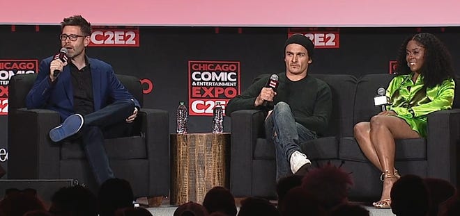 Inquisitors panel at C2E2 with moderator and actors sitting on couch holding microphones