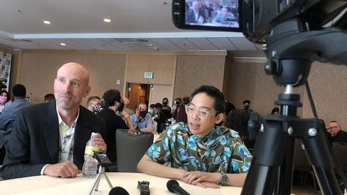 Image of Cliff Chiang and Brian K. Vaughan at interview table.