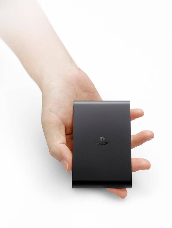 A hand holding the PlayStationTV unit