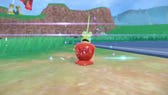 Pokemon Scarlet and Violet Dipplin: A large green worm with a tall vertical spike is popping out the top of a shiny red apple with red syrup glooping down the side.