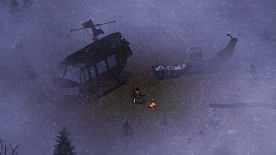 A survivor huddles round a campfire in the snow next to a crashed helicopter in Project Zomboid