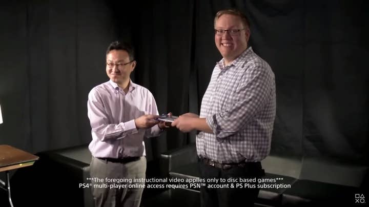 Sony's Shuhei Yoshida and Adam Boyes hold a game between them, smiling at the camera in an instructional video showing how lending games worked on the PS4