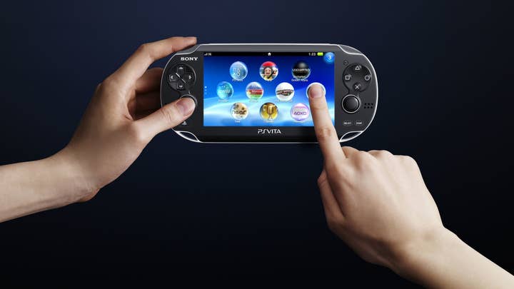 Promotional image of PlayStation Vita with one hand holding the system and another using the touchscreen
