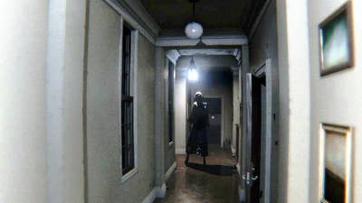 P.T. screenshot showing a somewhat grainy image of a realistic white hallway with a shadowed figure of a woman with an unnatural gait walking at the end of the hall
