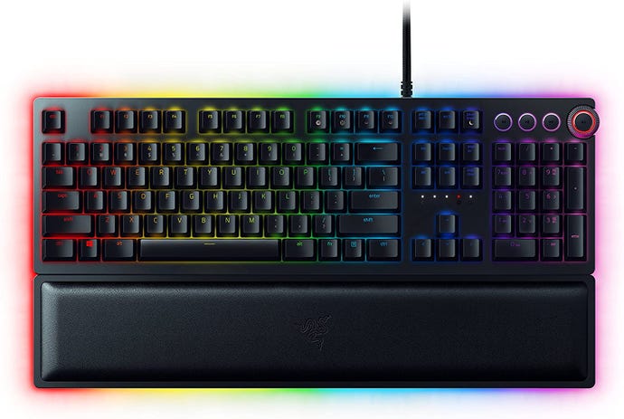 The Razer Huntsman Elite gaming keyboard, lit up with RGB and fronted by a wrist rest.