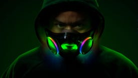 A man in a hood wearing Razer's Project Hazel face mask, and his face is illuminated by its interior RGB lighting