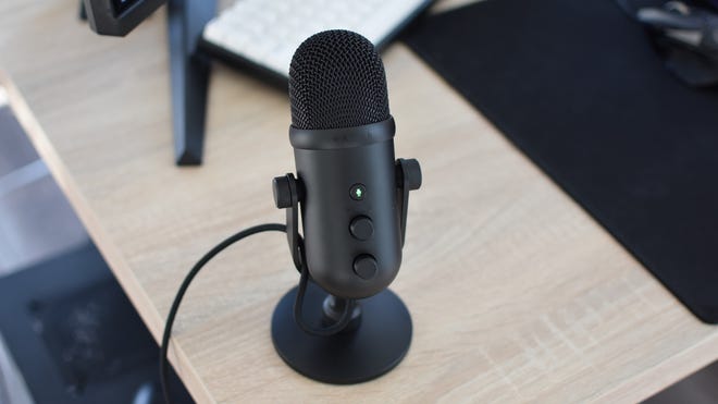 The Razer Seiren V2 Pro gaming microphone on a desk.