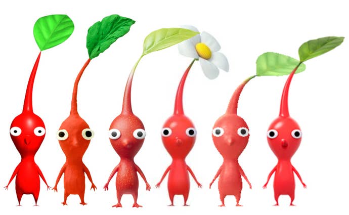 Red Pikmin stand in a line, most with leaves on their heads, but one has a daisy flower.