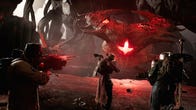 Three players take on a red-eyed, enormous alien in Remnant 2.