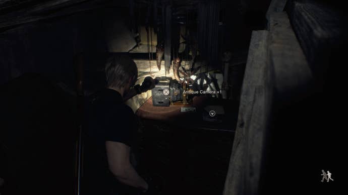 Leon Kennedy collecting an antique camera as part of the Savage Mutt quest in Resident Evil 4