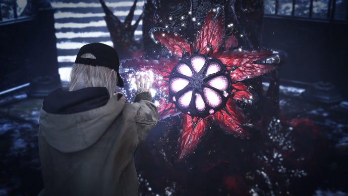Rose focuses on a red and purple flower in Resident Evil Village's Shadows Of Rose DLC