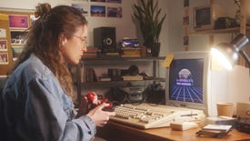 A PC gamer plays a retro-style game on an old CRT using a joystick