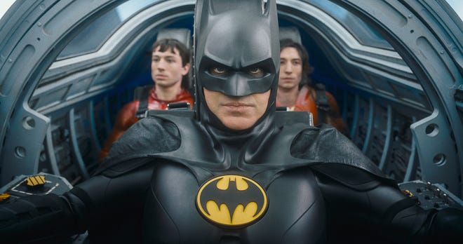 Production still featuring Batman and two Flashes behind him