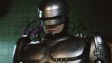 RoboCop: Rogue City promo screenshot showing RoboCop in a medium close-up looking stern in front of a graffitied wall.