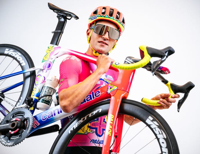 A photo of Ruben Guerreiro wearing his ugly Palace X Rapha cycling kit with his ugly Palace X Rapha bike.